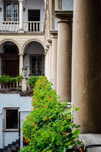 Italian courtyard with flowers on the railing