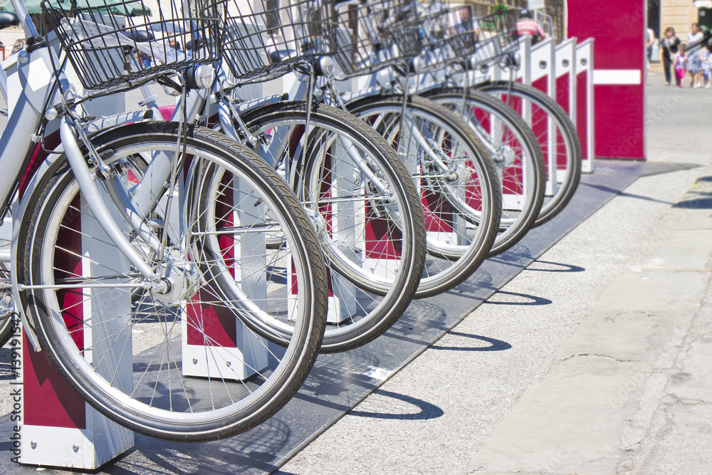 Five rental bicycles parked on a italian street - image with copy space Five rental bicycles parked on a italian street - image with copy space