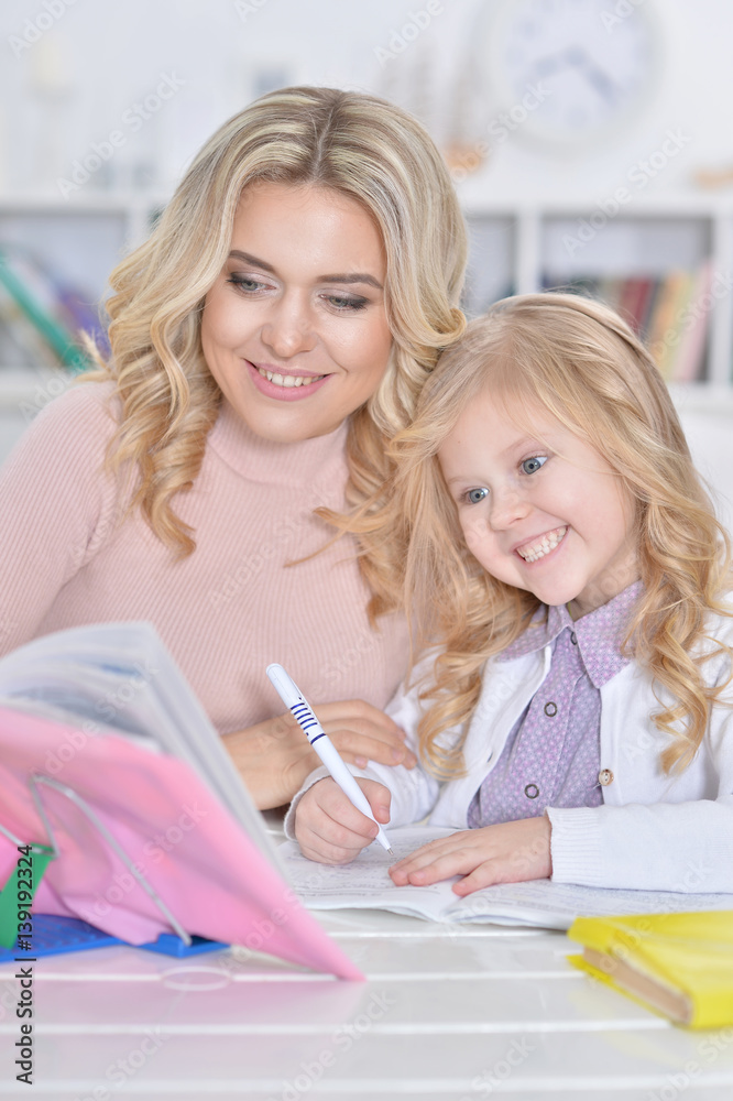 mother and daughter doing homework mother and daughter doing homework