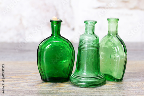 Coloured glass bottles on a rustic background