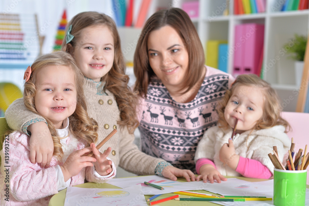 Mother and her three daughters drawing 