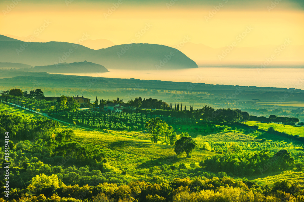Obraz premium Maremma sunset panorama. Countryside, sea and Elba on horizon. San Vincenzo, Tuscany, Italy.