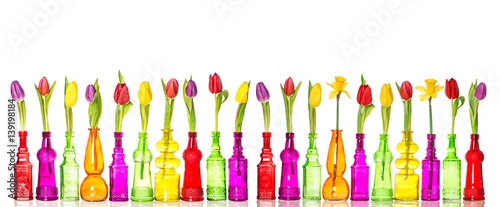 Tulips daffodil flowers glass bottles spring decoration