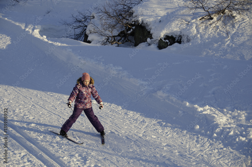 Girl sliding down on cross country ski