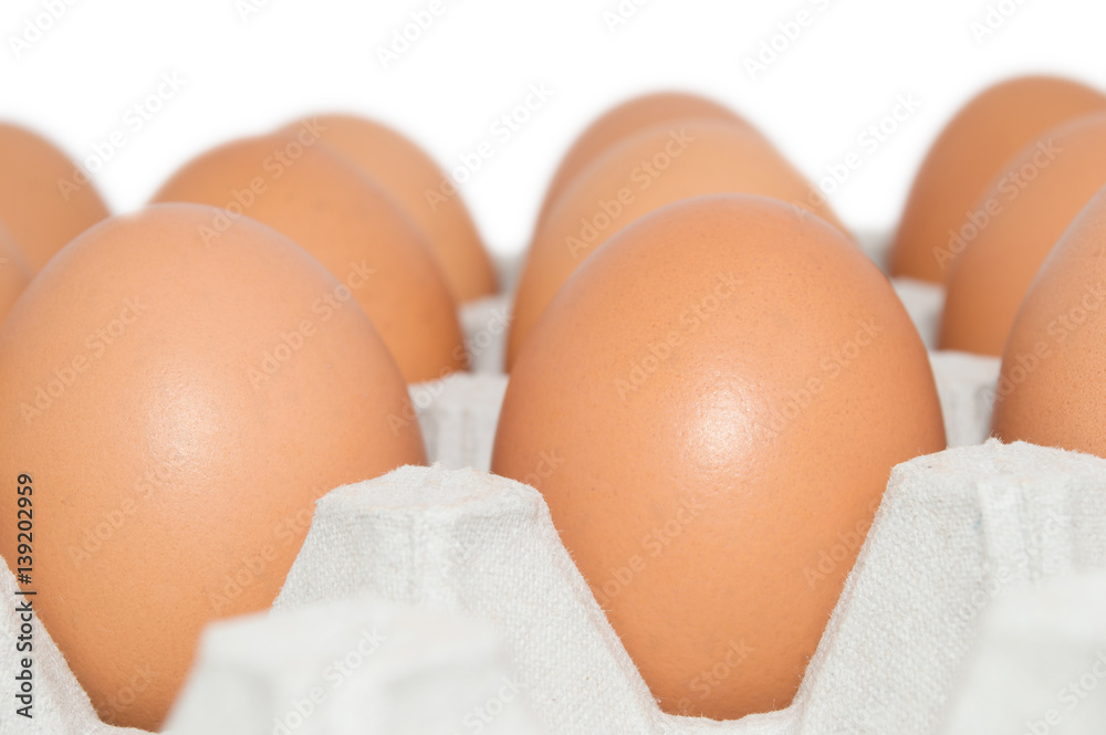 Brown eggs in container cardboard closeup isolated on white background Brown eggs in container cardboard closeup isolated on white background