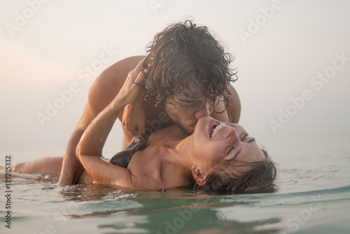 young couple kissing in the sea