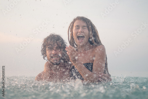 Photography young couple having fun in the sea