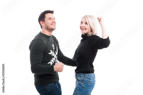 Smiling couple with raised hands