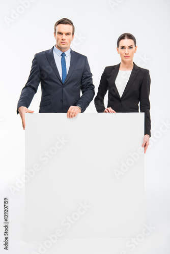 Businesspeople holding blank card