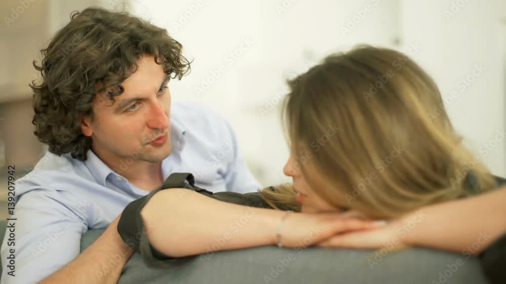 Man talking to his girlfriend who is looking to the camera
Man talking to his girlfriend who is looking to the camera