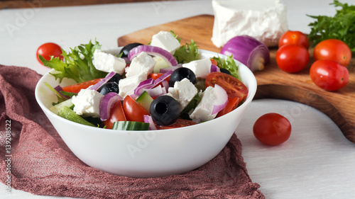 Greek salad with fresh vegetables, feta cheese and black olives photo