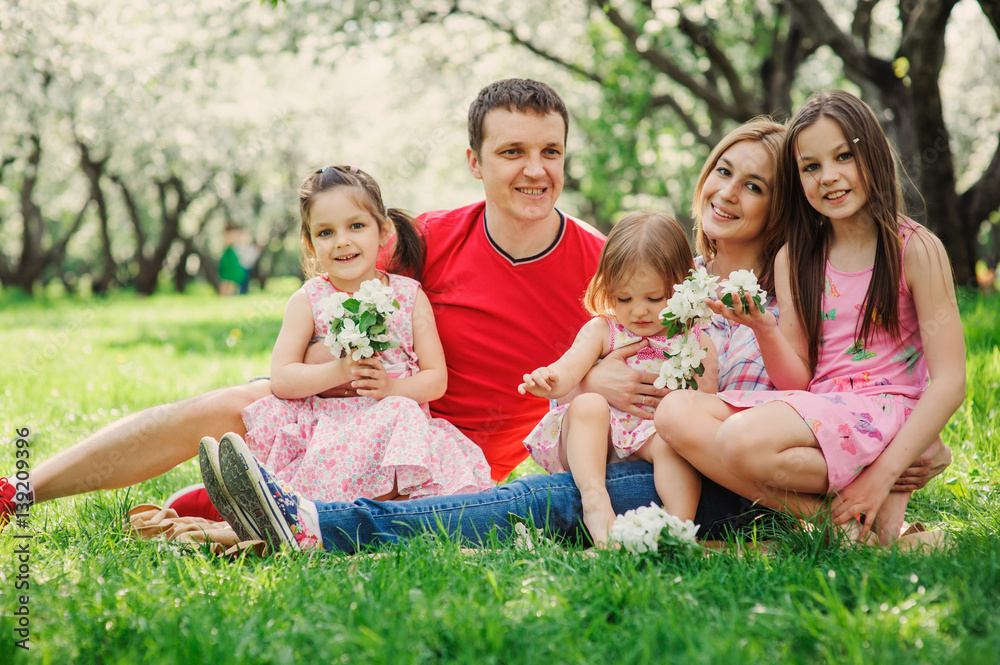 Fototapeta premium big family with three little daughters spending time together in summer park, mother, father and sisters having fun outdoor