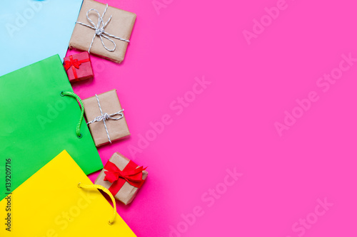 beautiful small gifts and colorful cool shopping bags on the wonderful pink background