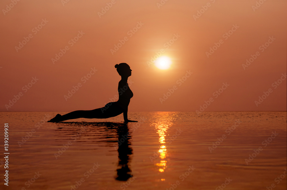 Yoga on the beach at sunset. Different correct asanas set in my portfolio