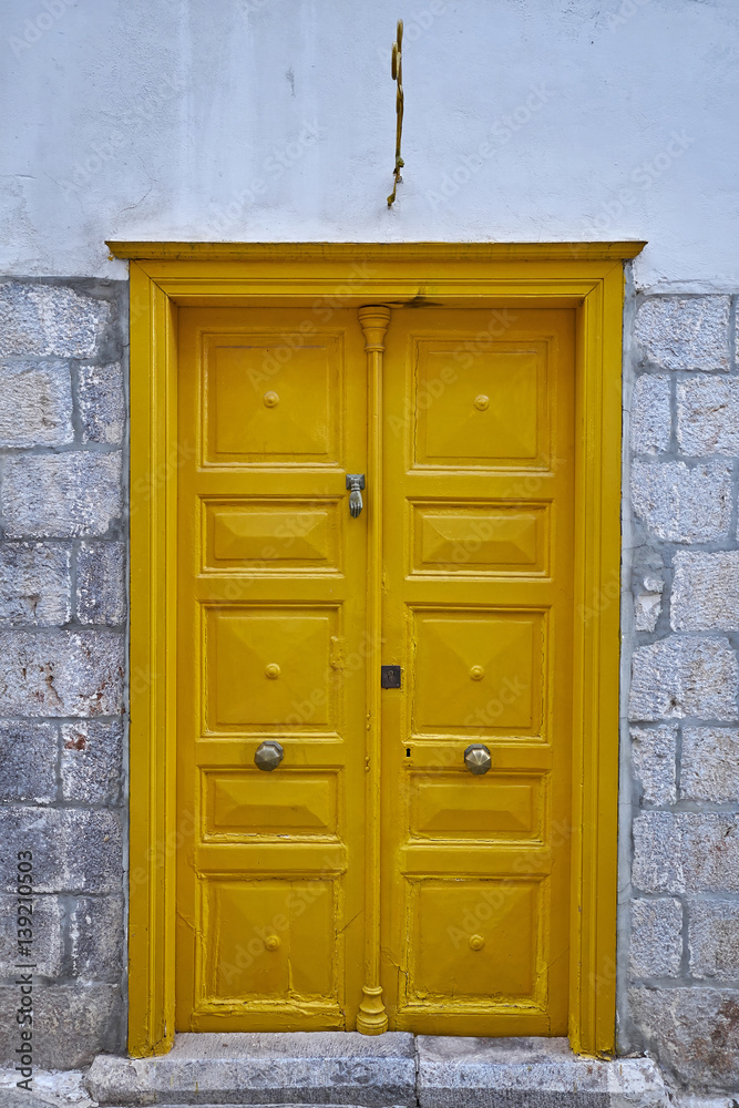 vintage house yellow door in a Greek island village