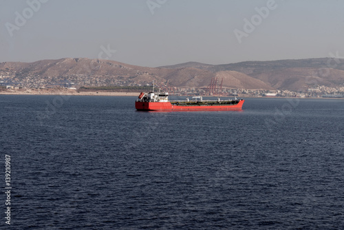 red cargo ship in the sea near Athens