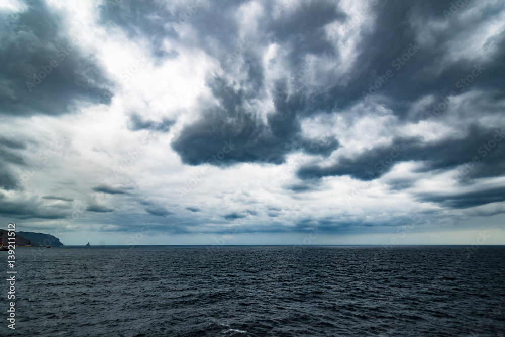 Atlantic Ocean with dramatic blue sky and clouds behind cruiser Atlantic Ocean with dramatic blue sky and clouds behind cruiser