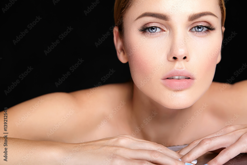 Fototapeta premium beautiful woman model with no makeup and clean healthy skin face on black background.