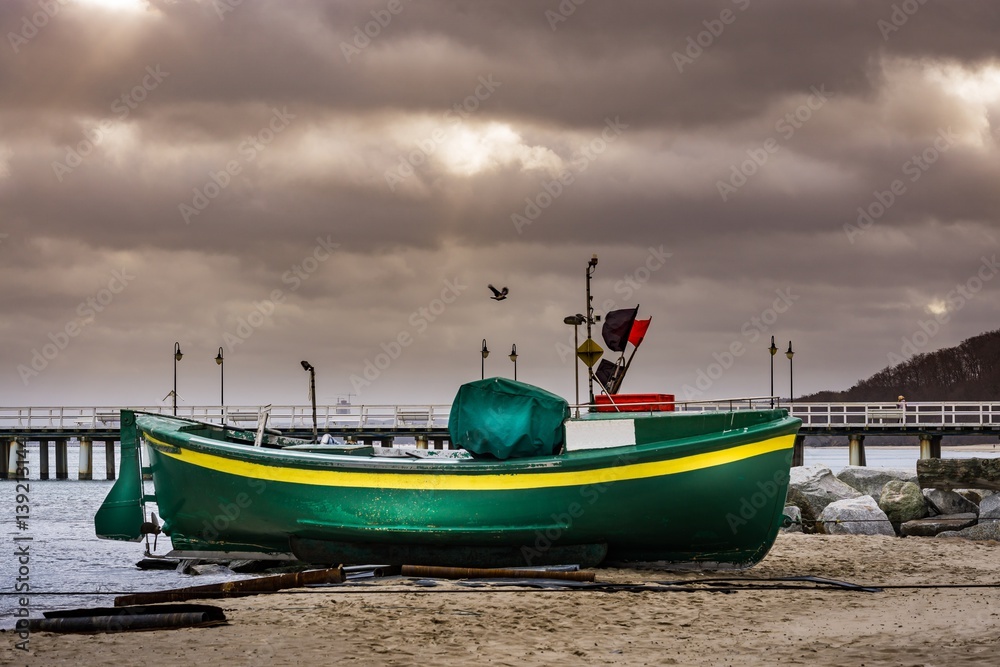 Fishing Boat on the beach of Baltic sea at storm