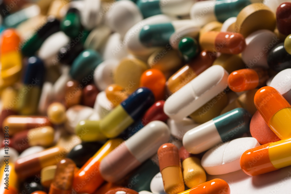 Multiple pills depicting medical treatment or pahrmaceutical industry. High resolution image.