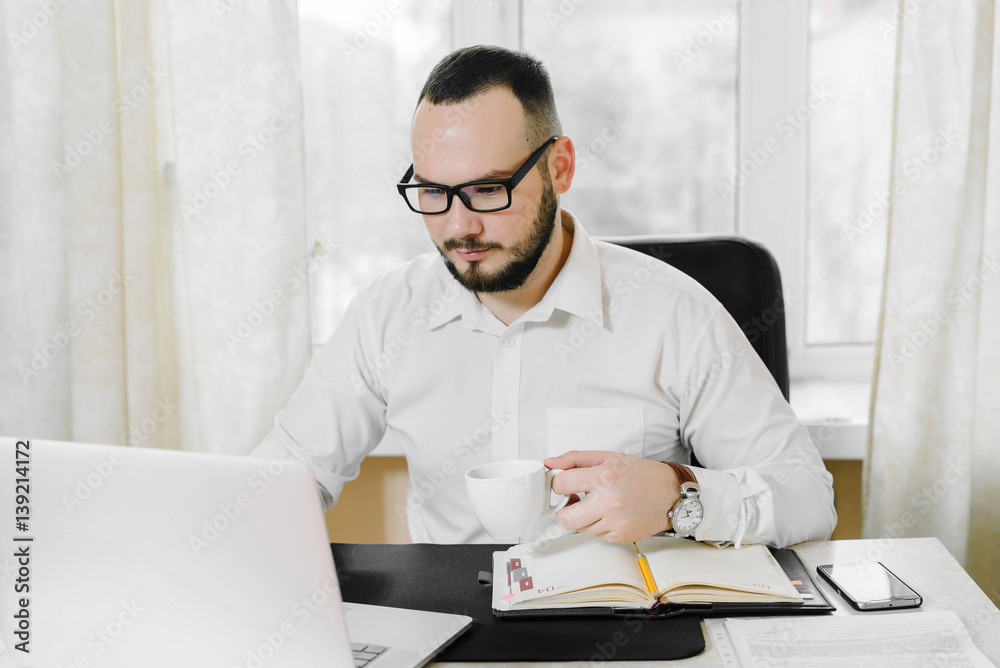 businessman drinking coffee in the workplace businessman drinking coffee in the workplace