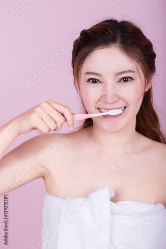 happy beautiful woman brushing her teeth