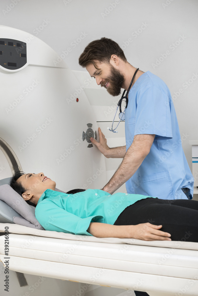 Obraz premium Doctor About To Start CT Scan On Female Patient