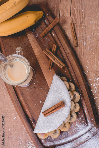 Tapioca Banana | Manioc flour pancake with caramelized banana, condensed milk and cinnamon - Typical food of the Brazilian Northeast photo