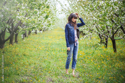 woman in jeans in cherry orchard © lanarusfoto
