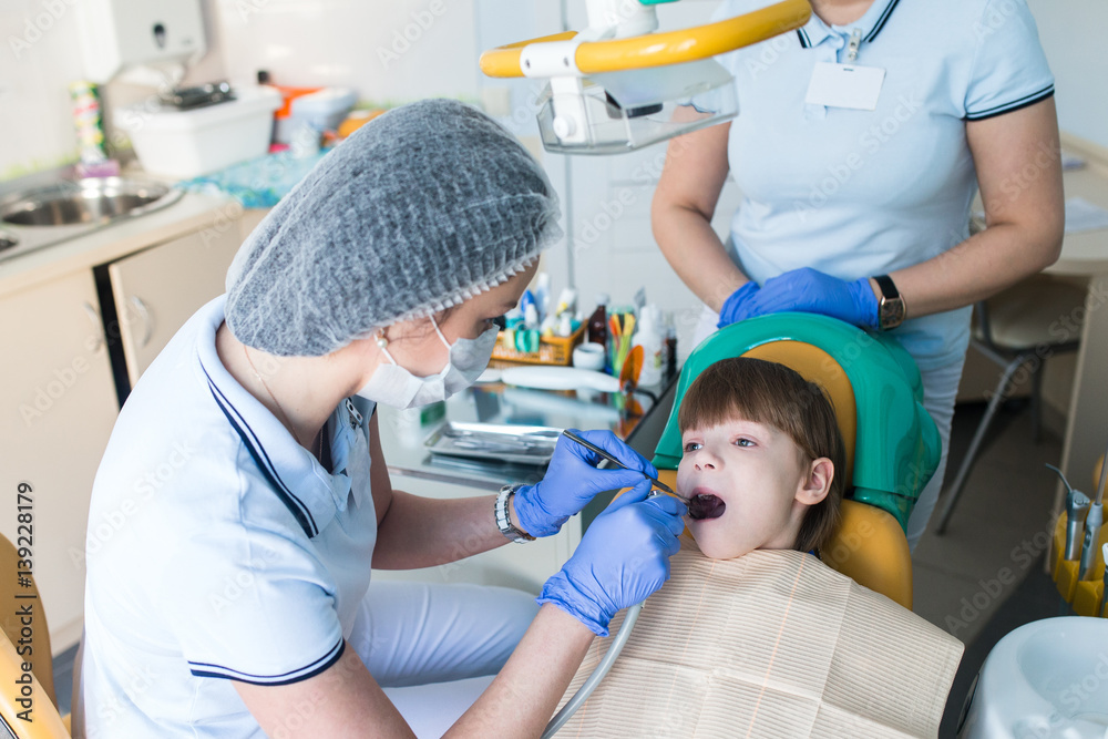 dentist and nurse curing childe teeth dentist and nurse curing childe teeth