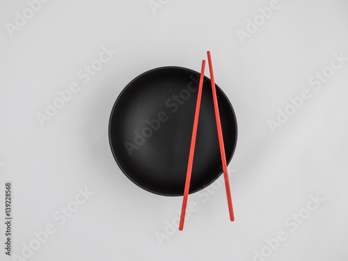 Black Japanese soup bowls with chopsticks.