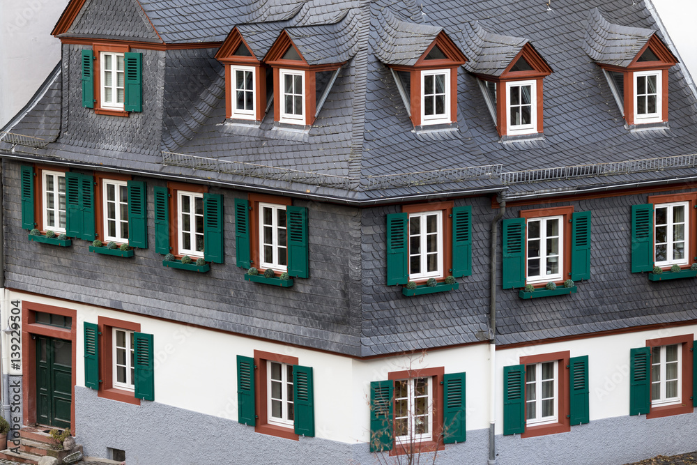 Fototapeta premium Typical German house with windows with shutters looks like a toy