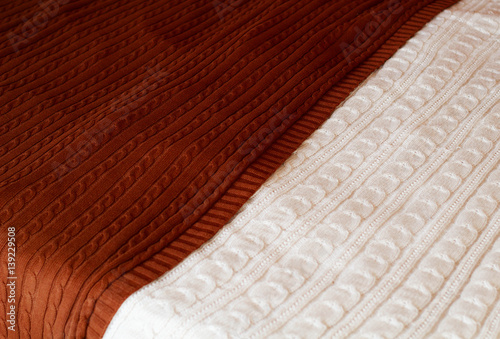 Picture of white and brown knitted blankets close up