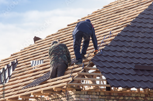 workers working on the roof © schankz