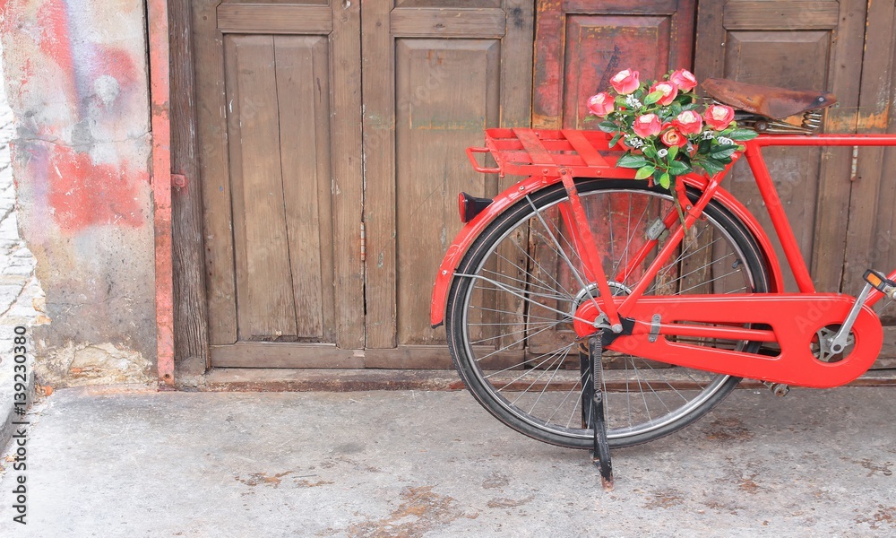 flower on saddle red bicycle classic vintage on wall wood background with copy space for add text
