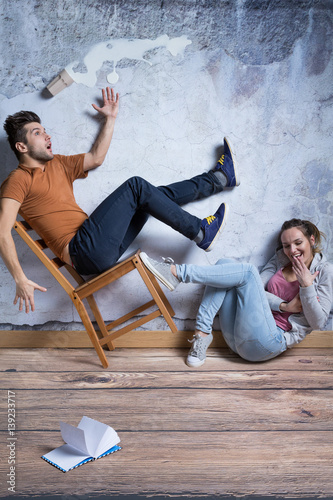Man on toppling chair photo