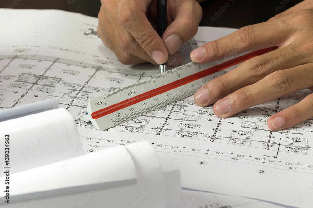 Workplace of architect - Architect rolls and plans.architectural plan,technical project drawing. Engineering tools view from the top. Construction background Workplace of architect - Architect rolls and plans.architectural plan,technical project drawing. Engineering tools view from the top. Construction background