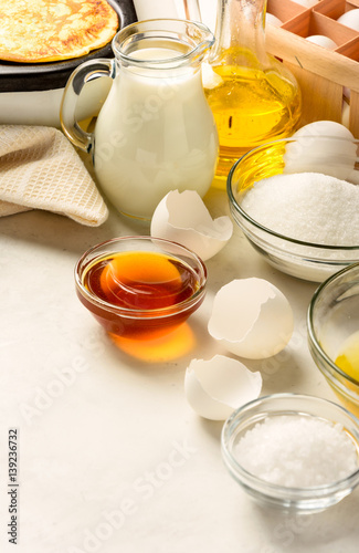 Ingredients for making pancakes on a white background. Copy space.