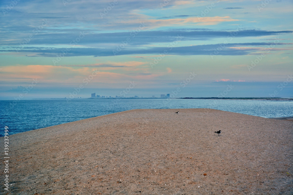 Fototapeta premium Sunrise Over Ocean and Atlantic City Off in the Distance
