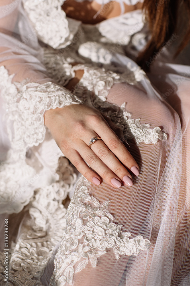 beautiful young sweet blonde girl with a wedding bouquet in the hands of the boudoir in a white dress with evening hairstyle walks near the ruins beautiful young sweet blonde girl with a wedding bouquet in the hands of the boudoir in a white dress with evening hairstyle walks near the ruins