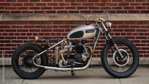 old motorcycle against brick wall