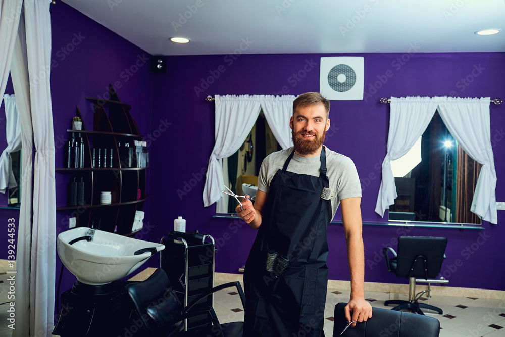 Hairdresser man with a beard scissors in his hands at hairdresser. Hairdresser man with a beard scissors in his hands at hairdresser.
