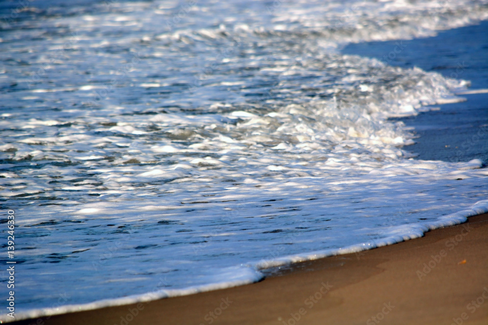 Waves Washing Up onto the Beach Along the Coastline