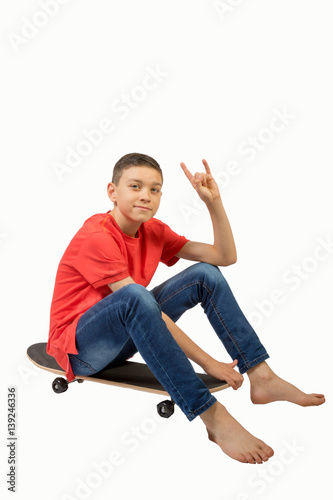 Young teenage caucasian boy with his skateboard
