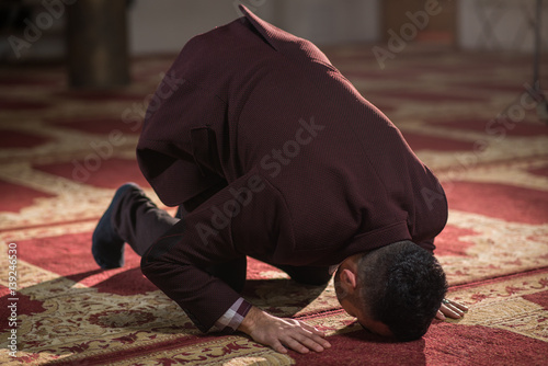 Muslim prostrating on the ground