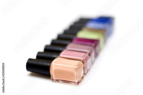 Coloured nail polish bottles on a white background