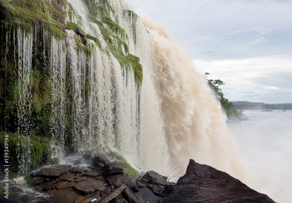 Fototapeta premium The profile view of the Hacha waterfall in the lagoon of Canaima national park after - Venezuela, Latin America