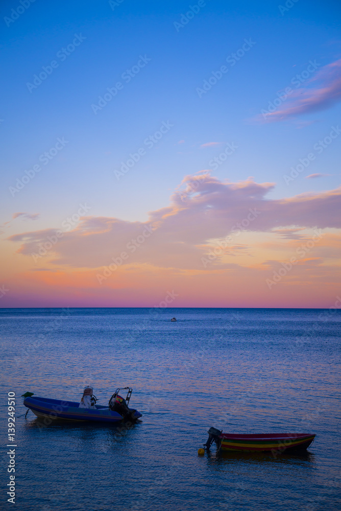 Beautiful cnad colorful pink, purple, blue and violet horizon sunset from the beach
