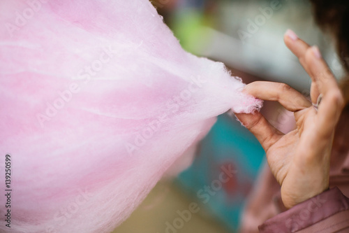 Person taking a piece of cotton candy photo