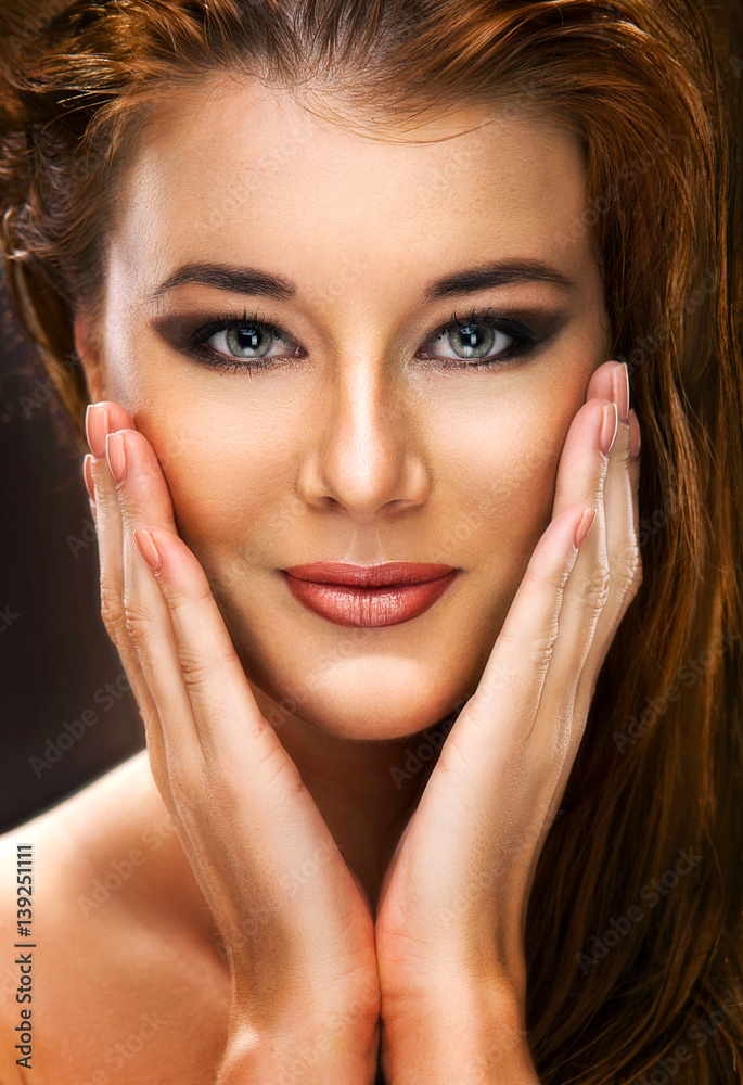 Portrait of a beautiful female model on dark background